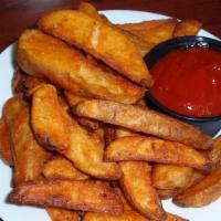 1 Lb Fries · One pound of seasoned wedge fries served with a side of ketchup.