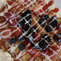 Very Berry Crêpes · Three crêpes topped with strawberries, blueberries and raspberries.