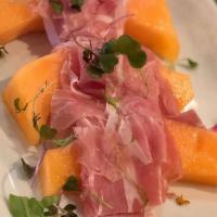 Prosciutto Di Parma E Melone · Cured ham over melon.