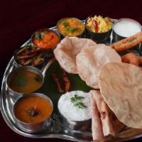 Tiffin Thali · Two idlis, one dosa, one vada, upma, one chapathi/poori, dessert.