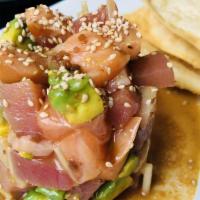 Tuna Tartare · Chopped tuna, scallion and sesame with spicy garlic sauce, served with wonton chips.