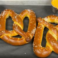 Hot Pretzels · 2 fresh baked salted pretzels served with queso dip and spicy brown mustard