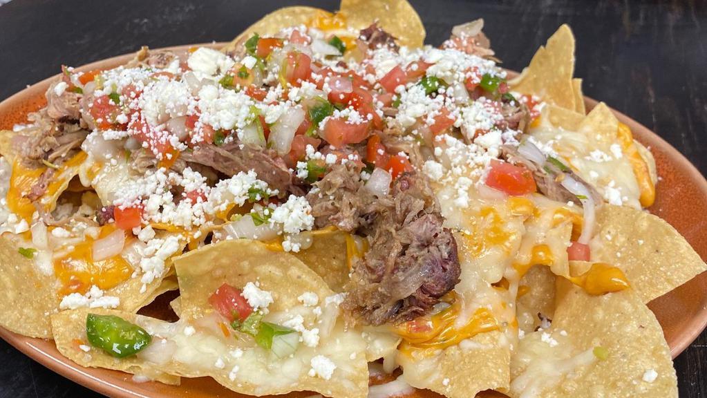 Pulled Pork Nachos · Pulled Pork Nacho's
Topped with queso and fresh pico de gallo