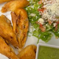 Southwestern Chicken Eggrolls · Tender chicken, corn, black beans and peppers in a crispy flour tortilla shell served with s...