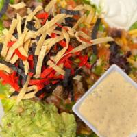 Texas Fajita Steak Salad · Crisp greens, topped with grilled fajita steak, pico, crisp corn tortilla strips, guacamole,...