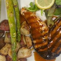 Lambeau’S Grilled Salmon  · 10oz salmon steak, marinated in an Asian ginger sauce, served with grilled asparagus and roa...