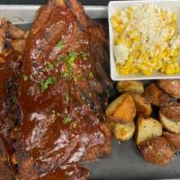 Kansas City Pork Ribs Full Rack · Slow smoked pork ribs, served with curly fries and roasted street corn.