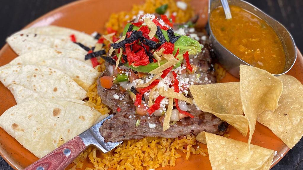 Charger Carne Asada · Grilled fajita steak, topped with fresh avocado, pico de gallo and queso fresco, served with flour tortillas, rice and charro beans.