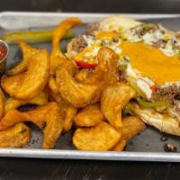 Philly Cheesesteak · Thin sliced steak, topped with grilled peppers, onions, and melted cheeses.