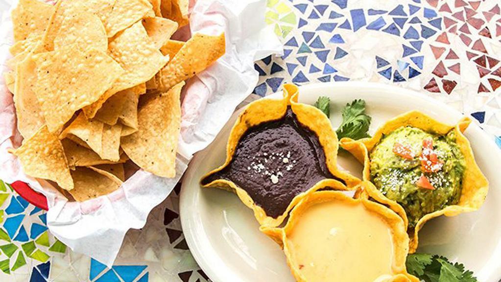 Zuzu Trio · A trio of our famous corn chip cups filled with guacamole, queso, and puréed black beans.