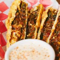 Smokin’ Tailpipes · 4 smoked brisket, pork, onions, jalapenos, cilantro, corn & peppers wrapped up and deep frie...