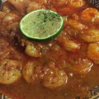 Shrimp Peal Peal · Gluten-free. Shrimp cooked in tomatoes, garlic, and Moroccan herbs and spices. Served with y...