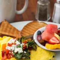 Greek Island Omelet · Spinach, tomato and feta cheese filled omelet topped with swiss.