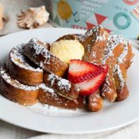 French Toast · Cinnamon swirl french toast, topped with powdered sugar. Served with bacon or sausage.
