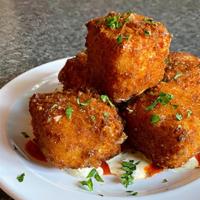 Fried Mac & Cheese Bites · Grandma’s Mac & Cheese, crispy on the outside and gooey on the inside, served with Zesty Ran...
