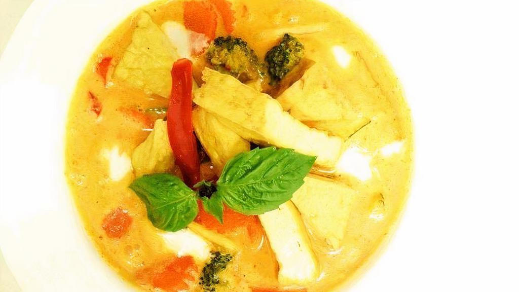 Red Curry · Soft tofu with seasonal vegetables, bamboo shoots, bell peppers. Cooked in red curry, topped with fresh basil leaves.​