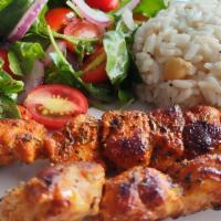Tavuk Şiş · two chicken skewers marinated in pepper paste,
garlic and Syrian olive oil, served with Turk...