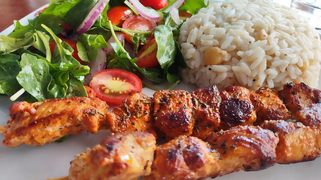 Tavuk Şiş · two chicken skewers marinated in pepper paste,
garlic and Syrian olive oil, served with Turkishspiced rice and seasonal salad. (gf)