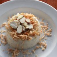 Keşkül · (Gluten-free). Turkish almond pudding, brûléed and topped with toasted coconut and almonds.
