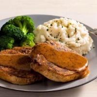 Caramel Mustard Glazed Pork Chops · A grilled pork chop served with two freshly made sides and Creole marmalade.