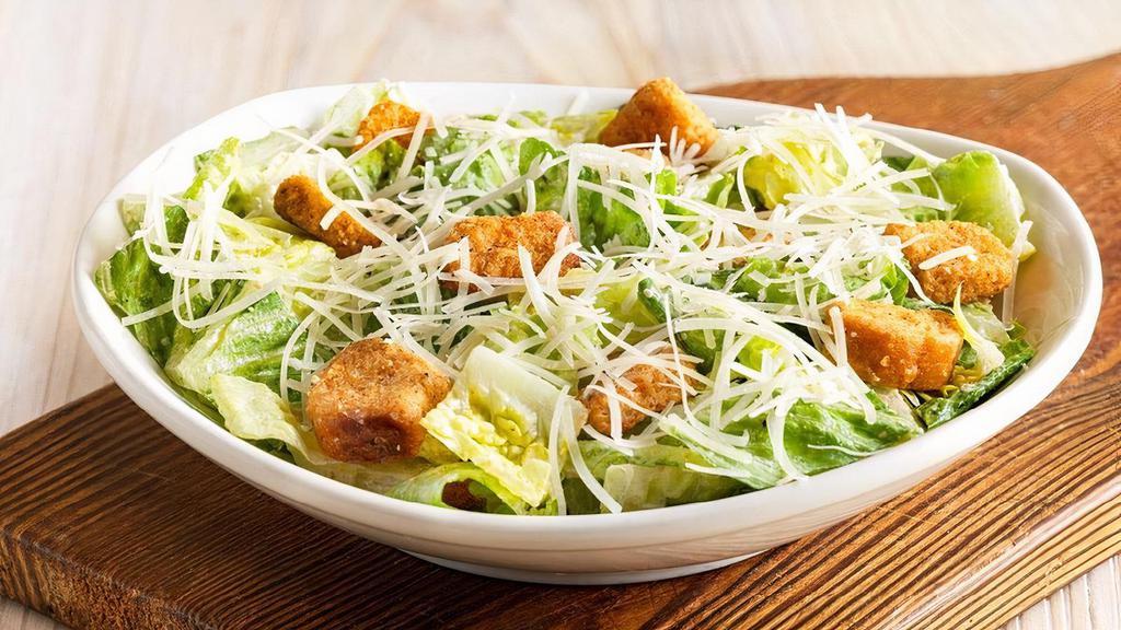 Caesar Side Salad · Romaine lettuce and homemade croutons tossed with traditional Caesar dressing. Topped with freshly grated Parmesan cheese.