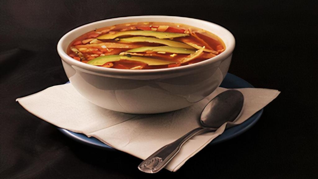 Tortilla Soup · Pieces of grilled chicken breast, with tortilla strips in a rich chicken broth, topped with avocado and Monterey Jack cheese and pico de gallo.