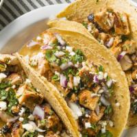 Chicken Tinga And Side · 3 Shredded chicken tacos on soft corn tortillas, topped with onion, cilantro and queso fresco