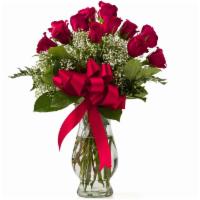 Debi Lilly Unforgettable Rose Arrangement · Custom designed dozen roses in a vase.