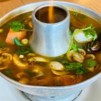 Tom Yum Talay (Seafood) · Hot and sour soup with a combination of seafood, (mussels, squid, salmon and prawns) mushroo...
