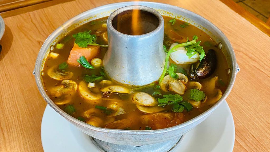 Tom Yum Talay (Seafood) · Hot and sour soup with a combination of seafood, (mussels, squid, salmon and prawns) mushrooms, lemongrass and cilantro.