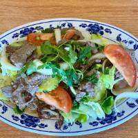 Crying Tiger (Beef Salad) · Beef tossed in lime dressing, peppers, garlic, cucumber, onions and tomatoes served over ice...