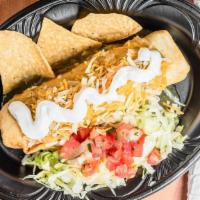 Green Chili Pork Chimichanga · A home-style tortilla filled with pork carnitas and seasoned rice and then smothered with gr...
