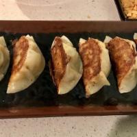 Gyoza  · 7 Pieces of pork pan fried dumplings.  It's ready to eat.