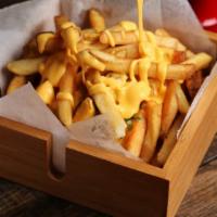 The Cheese Fries · Cheesy melted on fresh bed of potato fries.