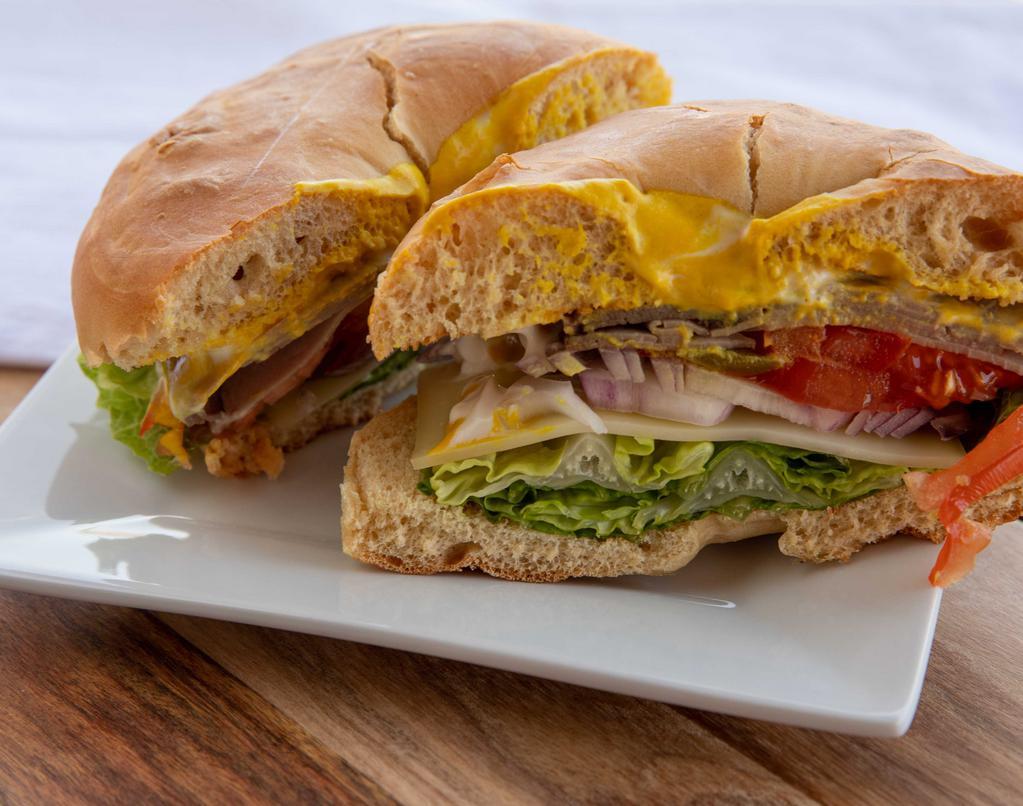 Roasted Beef · Roasted beef, pickles, tomatoes, onions, lettuce, Swiss cheese, mayonnaise & mustard.