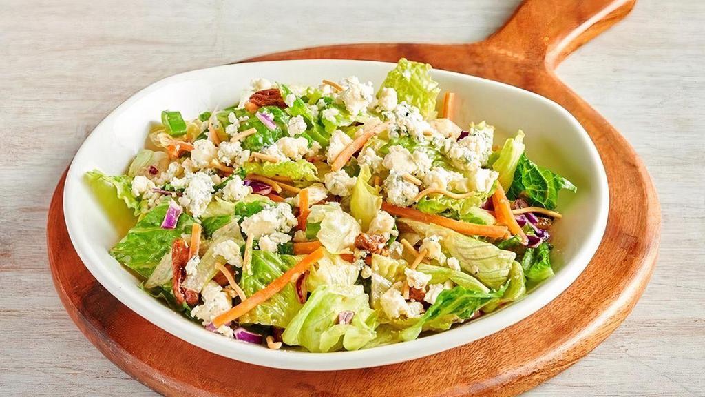Blue Cheese Pecan Chopped Side Salad** · Chopped style mixed greens with shredded carrots, red cabbage, green onions, cinnamon pecans and Aussie Crunch all tossed with Blue Cheese vinaigrette and topped with Blue Cheese crumbles.