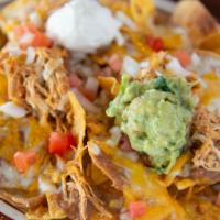 Super Nachos · Chips, cheese, beans, guacamole, sour cream, tomatoes and onions. Choose from ground beef, s...