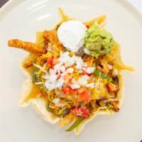 Deluxe Fajita Taco Salad · Our famous marinated meat sautéed with green peppers, onions, lettuce, cheese, tomatoes, oni...