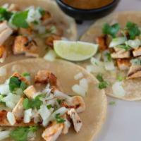 Street Tacos · Three tacos with fresh corn tortillas, topped with fresh onions, cilantro and homemade salsa.