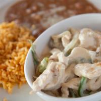 Pollo A La Crema · Strips of chicken breast sautéed in a special garlic cream sauce, peppers, mushrooms, rice, ...