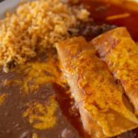 Enchiladas Tradicionales (2) · Corn tortilla filled with ground beef, shredded beef or chicken, smothered in our signature ...