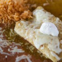 Enchiladas Suizas (2) · Corn tortillas filled with shredded chicken, smothered in tomatillo sauce, jack cheese and s...