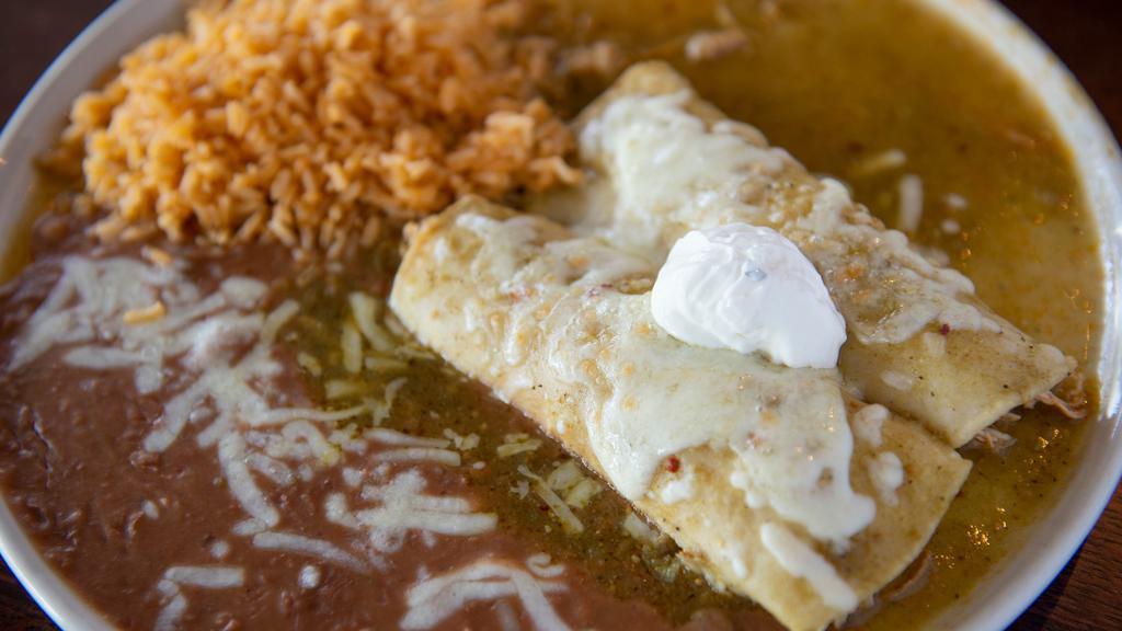 Enchiladas Suizas (2) · Corn tortillas filled with shredded chicken, smothered in tomatillo sauce, jack cheese and sour cream on top.
