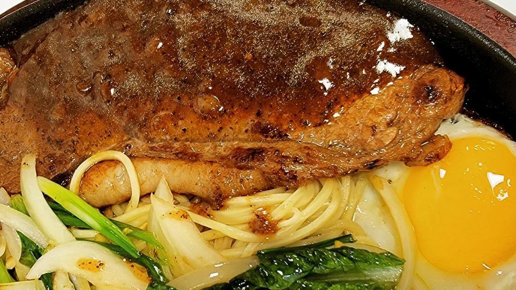 Teppan Steak · Pan fried steak with sauté vegetables and onions on a bed of noodles/rice. Choice of black pepper or mushroom sauce