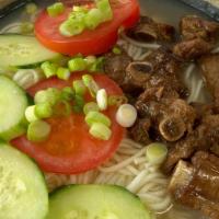 Pork Spareribs Noodles · Pork spare ribs in bone broth with noodles and vegetables.