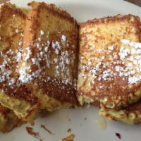 French Toast · Three large slices of home-style French toast, garnished with powdered sugar.  
Served with ...