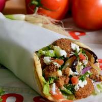 Falafel Supreme Pita Wrap · Homemade Falafel, served with fried eggplant and cauliflower topped with mixed salad, Feta a...