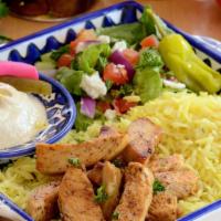 Chicken Shawarma Plate · Seasoned and grilled chicken breast served over a bed of rice, with side of Greek salad, Hum...