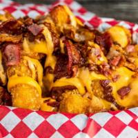 Totchos · Tater tots topped with beef chili, cheese sauce, bacon bits,pickled jalapeños, drizzled with...