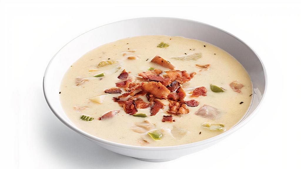 New England Clam Chowder · Red Skinned Potatoes, Ocean Clams, Green Peppers, Onions, Celery, Herbs & Spices In A Creamy Broth. Pictured With Applewood-Smoked Bacon (+40 Cal).